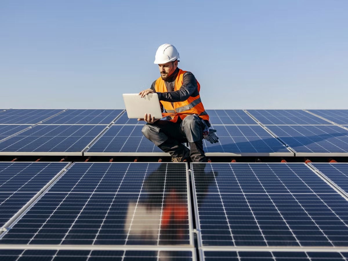 A person inspecting solar panels
