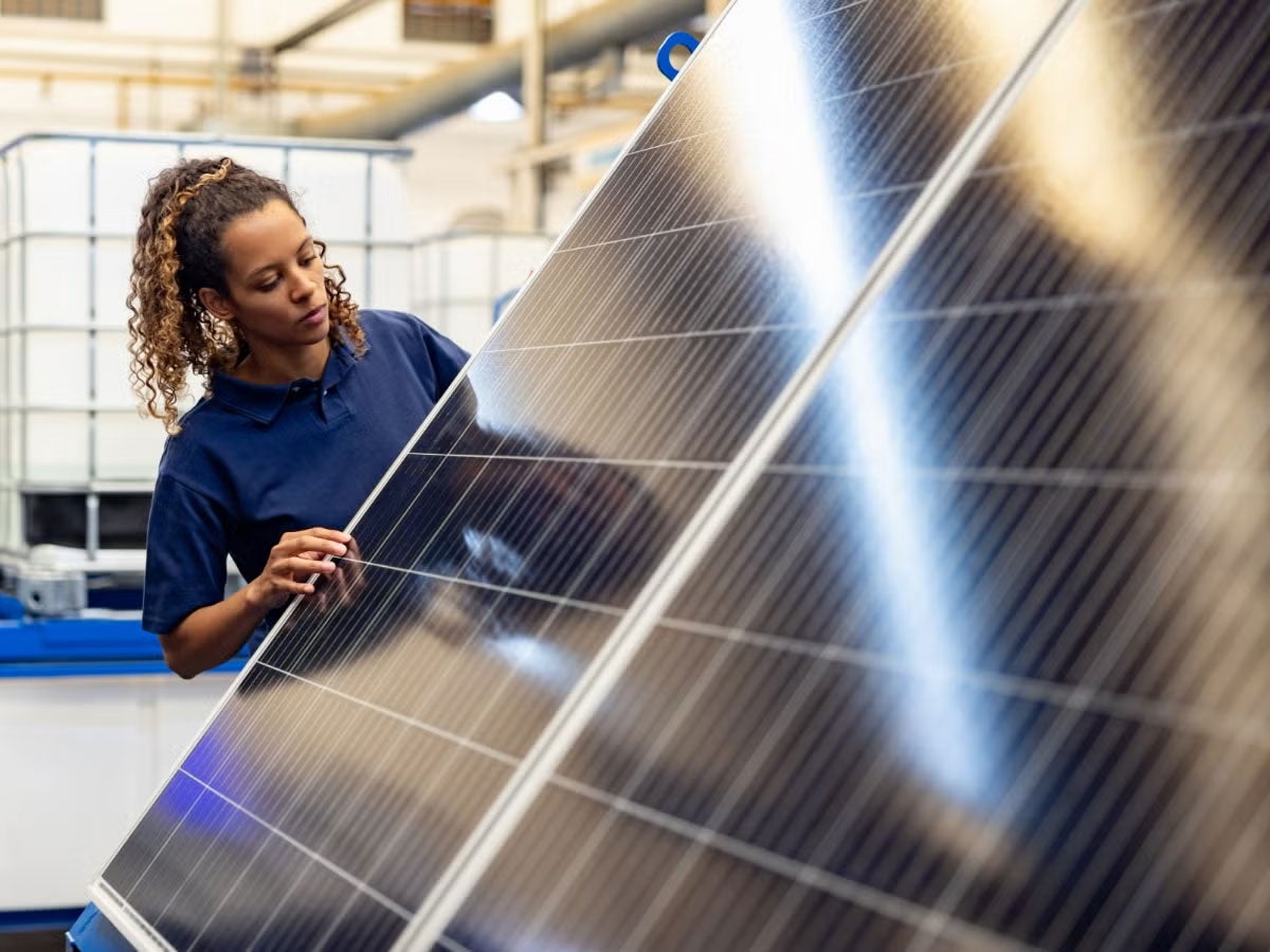 A person inspecting a solar panel