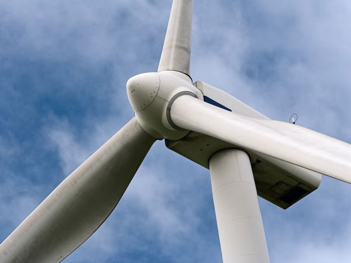 A wind turbine with the sky in the background