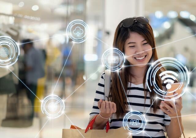 Shopper using their phone and the technology connected to it appears