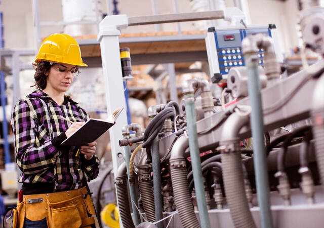 Woman engineer holding inspection report