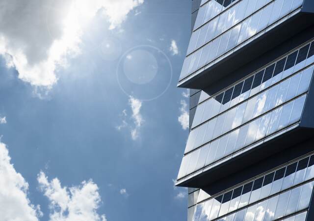 Building with solar panels, pictured on a bright but cloudy day