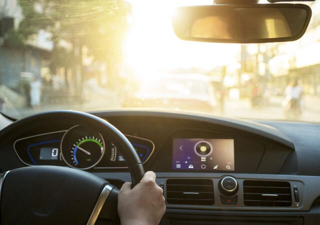A view as a driver looks out the front windshield of a car