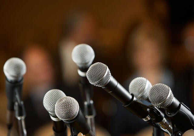 Several microphones on stands