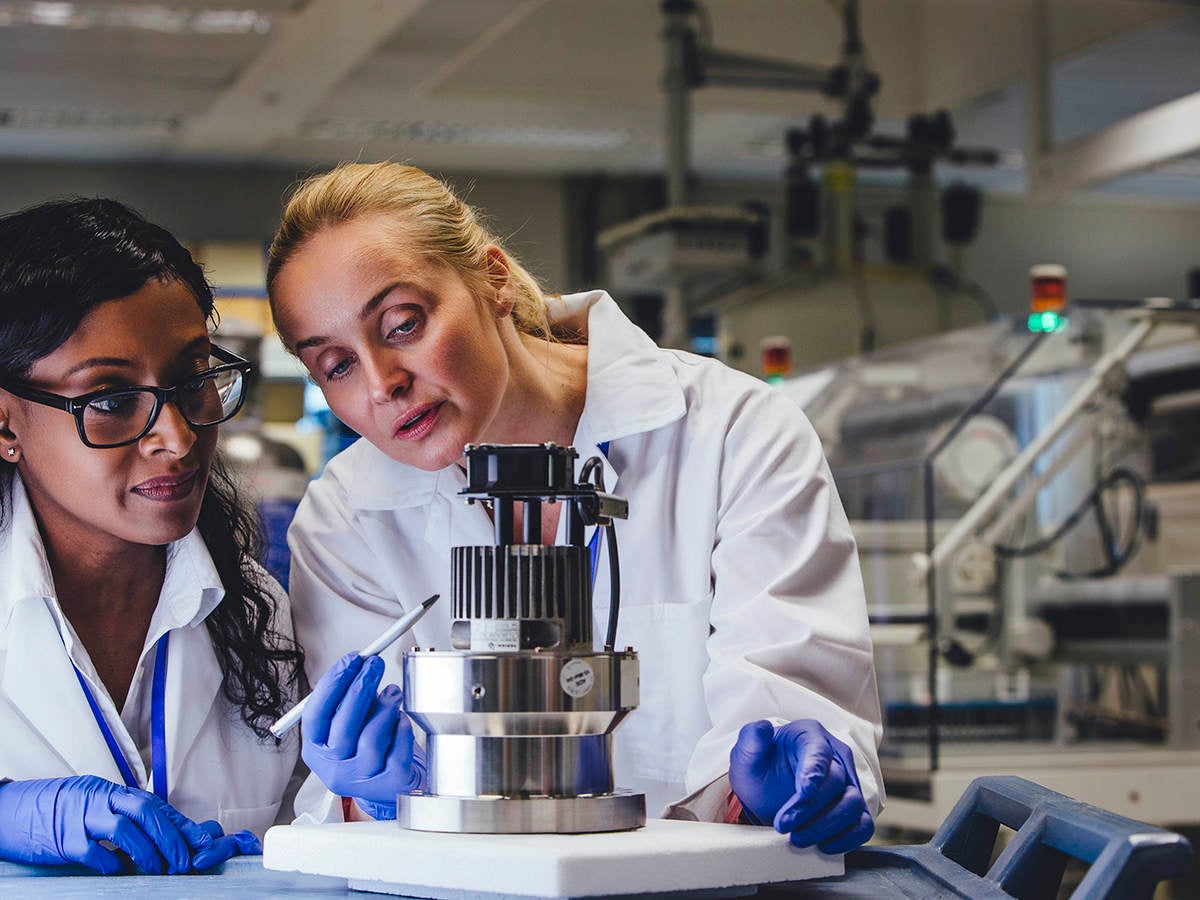 Two female medical engineers looking at test results