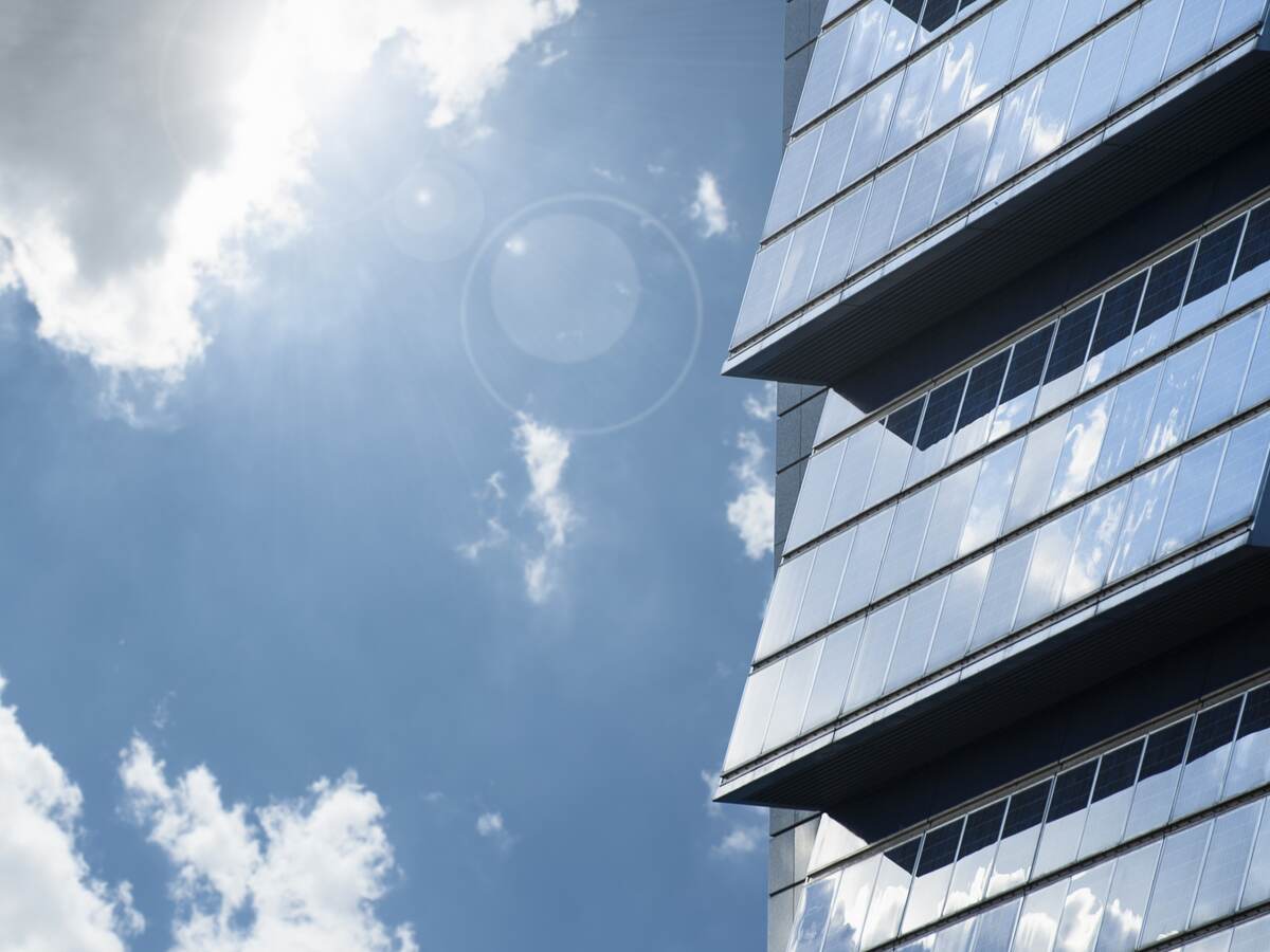 Building with solar panels, pictured on a bright but cloudy day