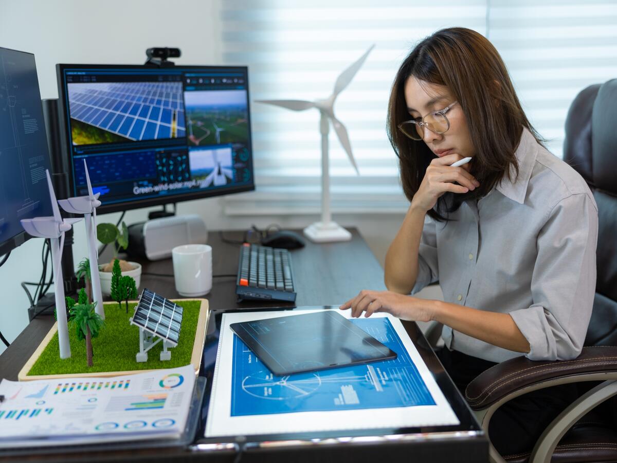 Wind renewables engineer working on a tablet