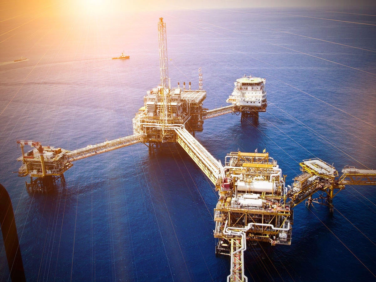 An offshore oil rig at sunset