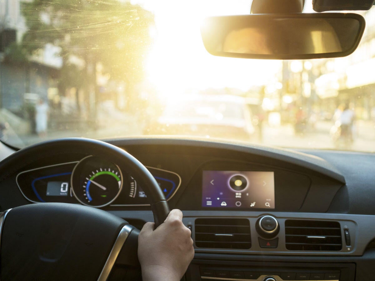A view as a driver looks out the front windshield of a car