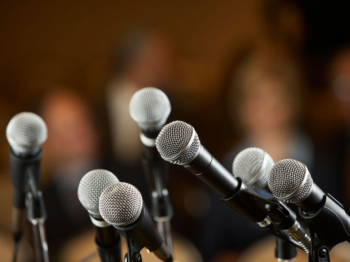 Several microphones on stands