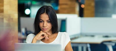 Woman looking on laptop screen