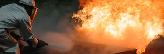 Fire fighter extinguishing fire 