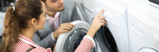 Young couple shopping for dryer