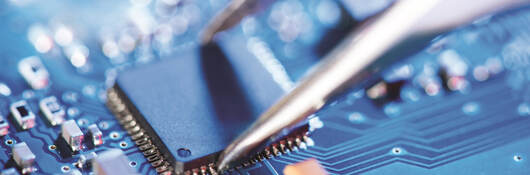 Tweezer being used on a circuit board