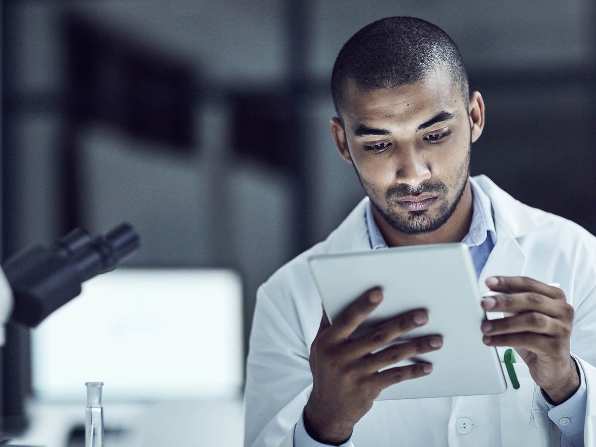 Man holding a tablet inside medical lab