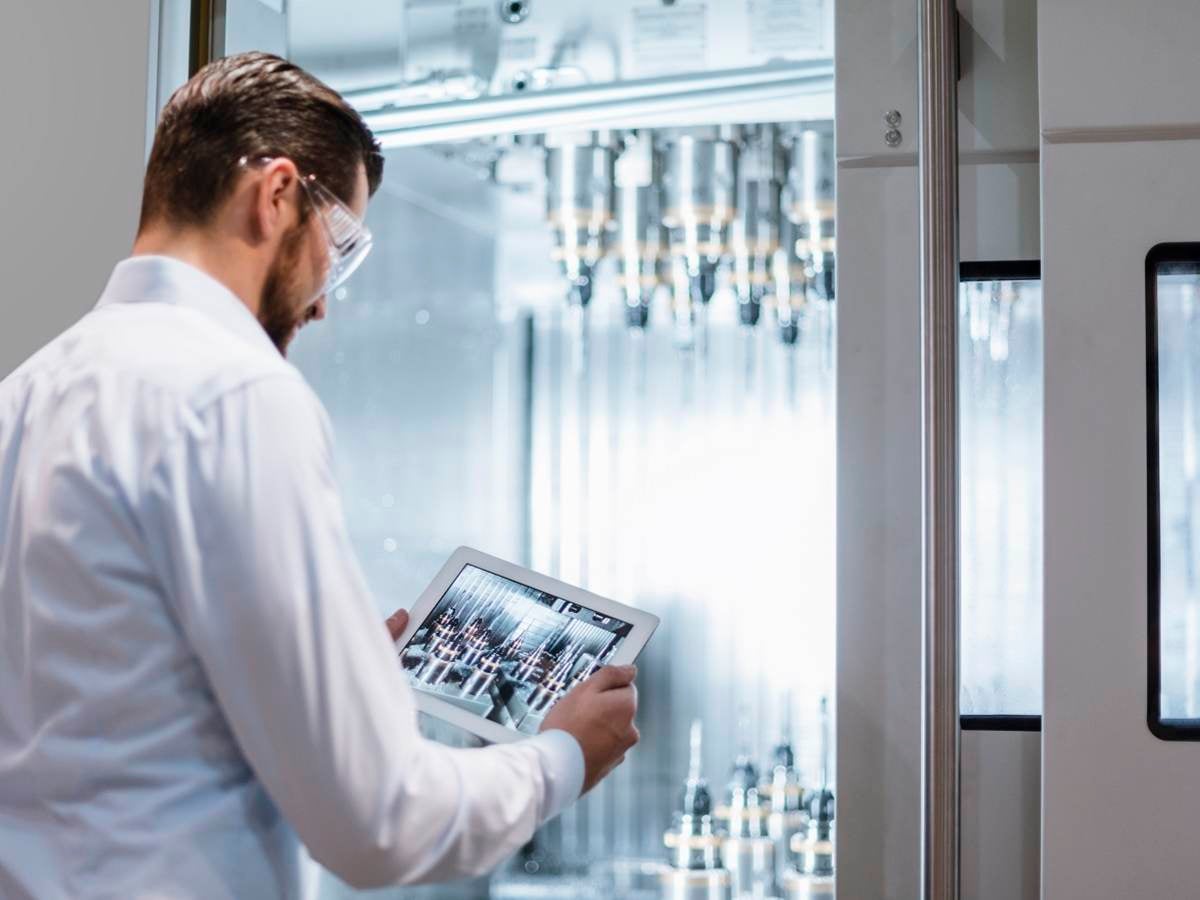 Engineer inside chemical lab looking at ipad